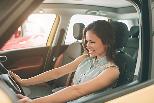 smiling woman driving a car