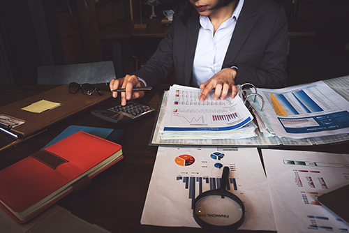 woman with financial charts and calculator