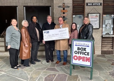 F&M Trust employees present a large check to Totem Pole Playhouse employees outside the playhouse box office.